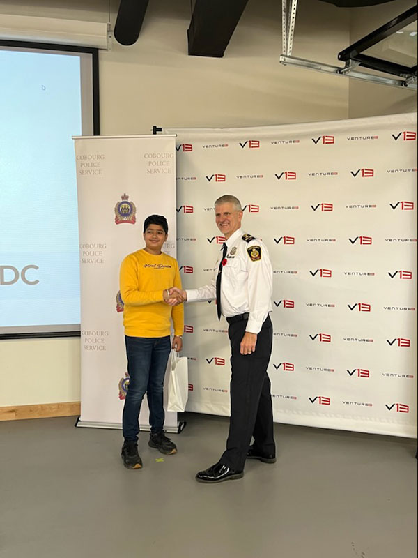 Pitch competition winner, Shaan Halaith, shakes hands with Cobourg’s Chief of Police, Paul VandeGraaf.